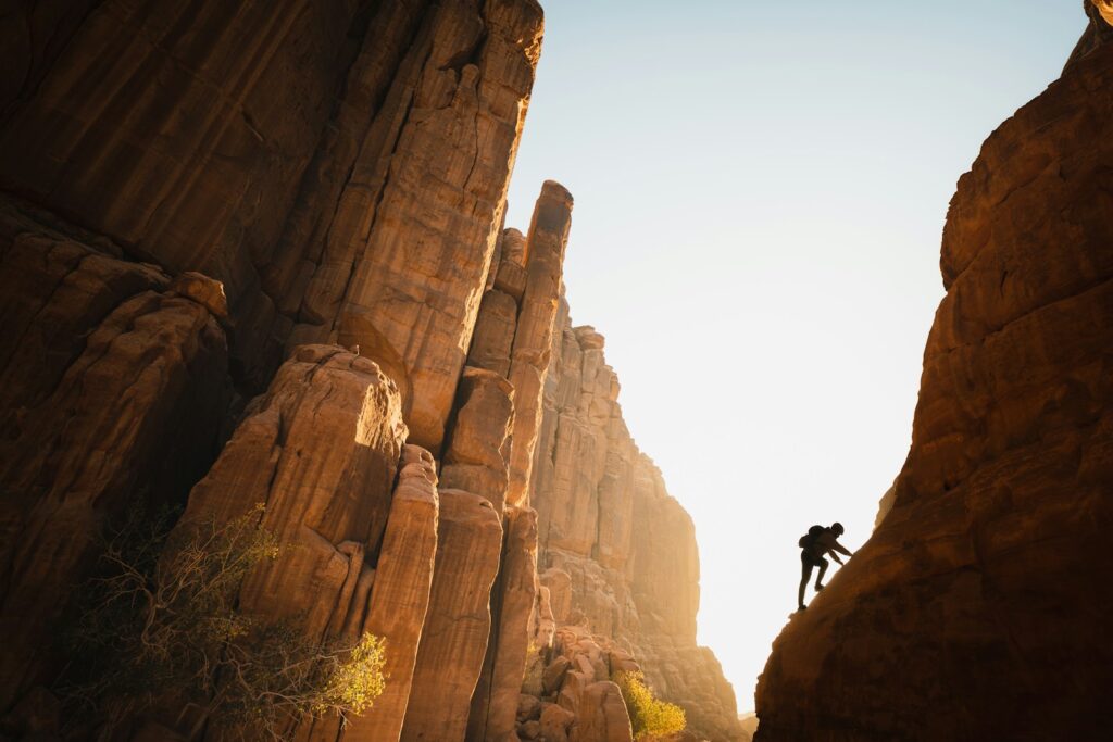 a man climbing up the side of a mountain