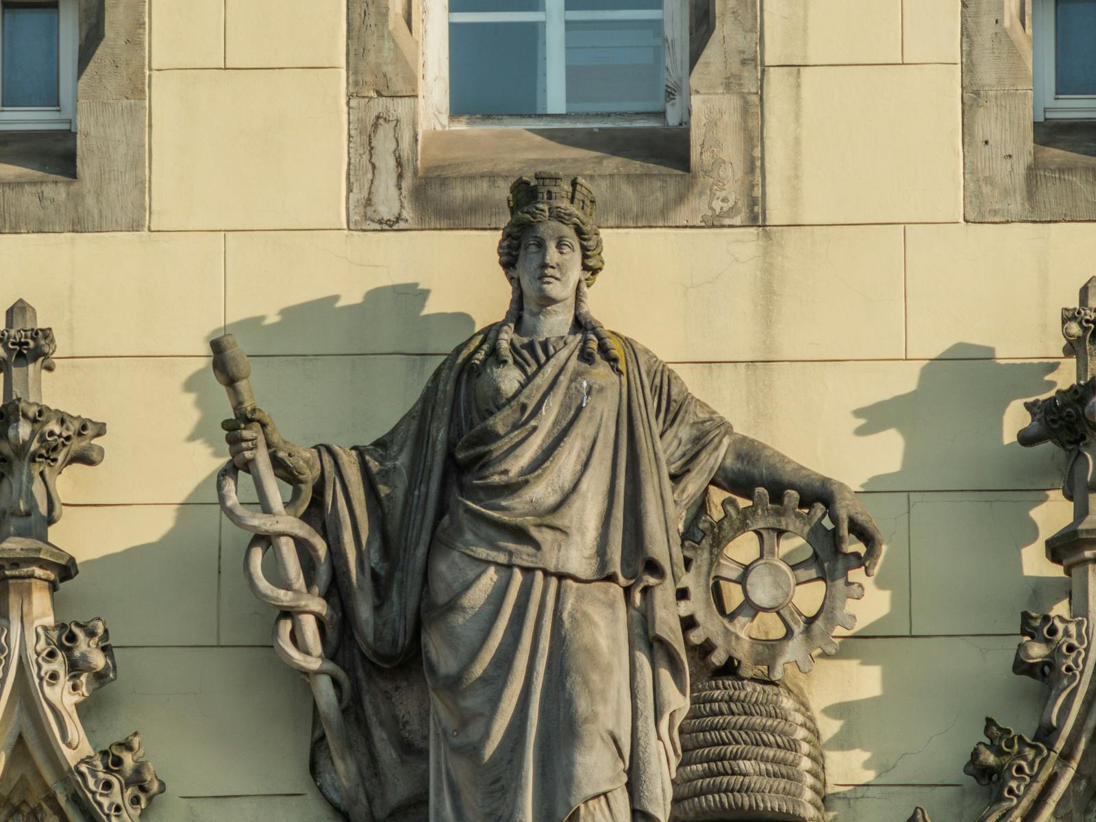 Detailed view of a classical sculpture on a historic building in Wrocław, Poland.